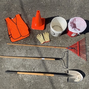 Tools needed to maintain a bioretention cell including rakes, shovel, buckets, gloves, safety vests and cones.