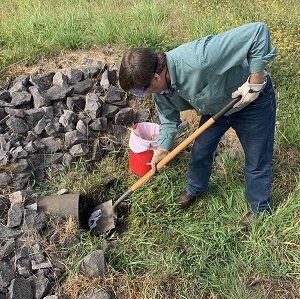 shoveling to clear an inlet pipe