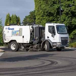 A vacuum street sweeper on permeable pavement.